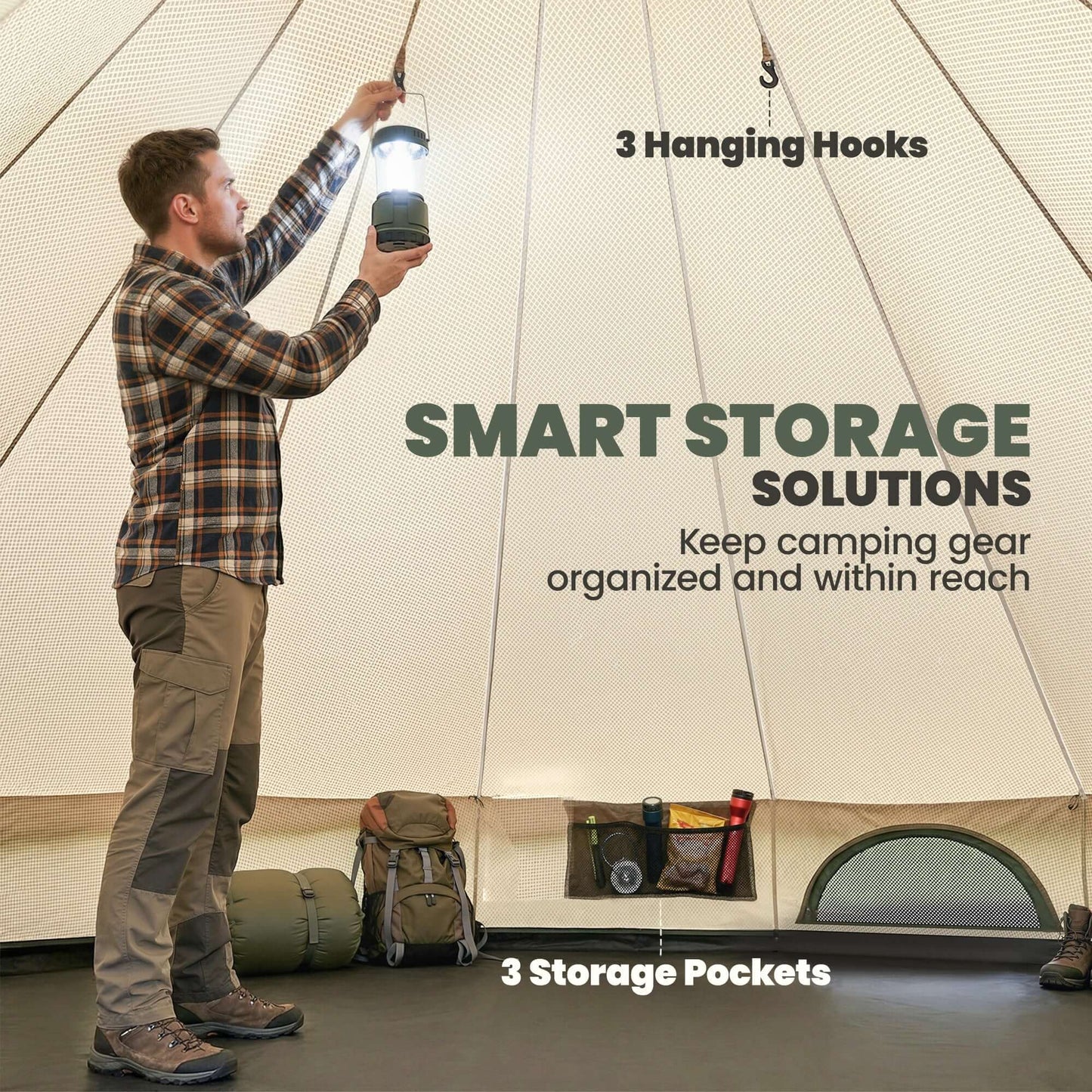 A man using a lantern in a camping tent with hooks and storage pockets, showcasing smart storage solutions.