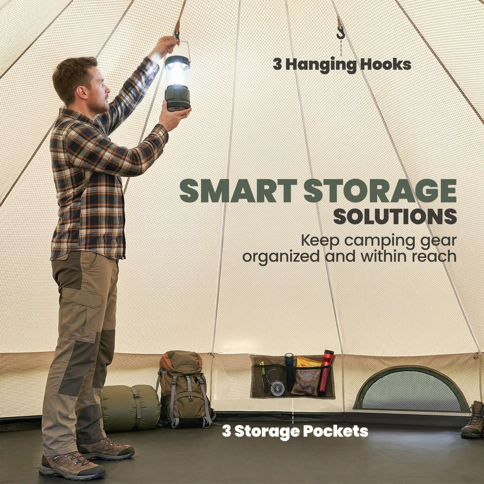 A man using a lantern in a camping tent with hooks and storage pockets, showcasing smart storage solutions.