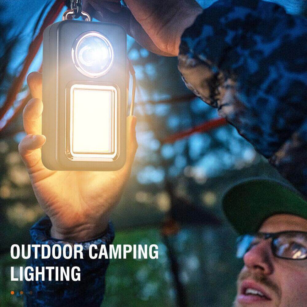 A person using a Solar Portable Camping Lantern for outdoor camping lighting at night.